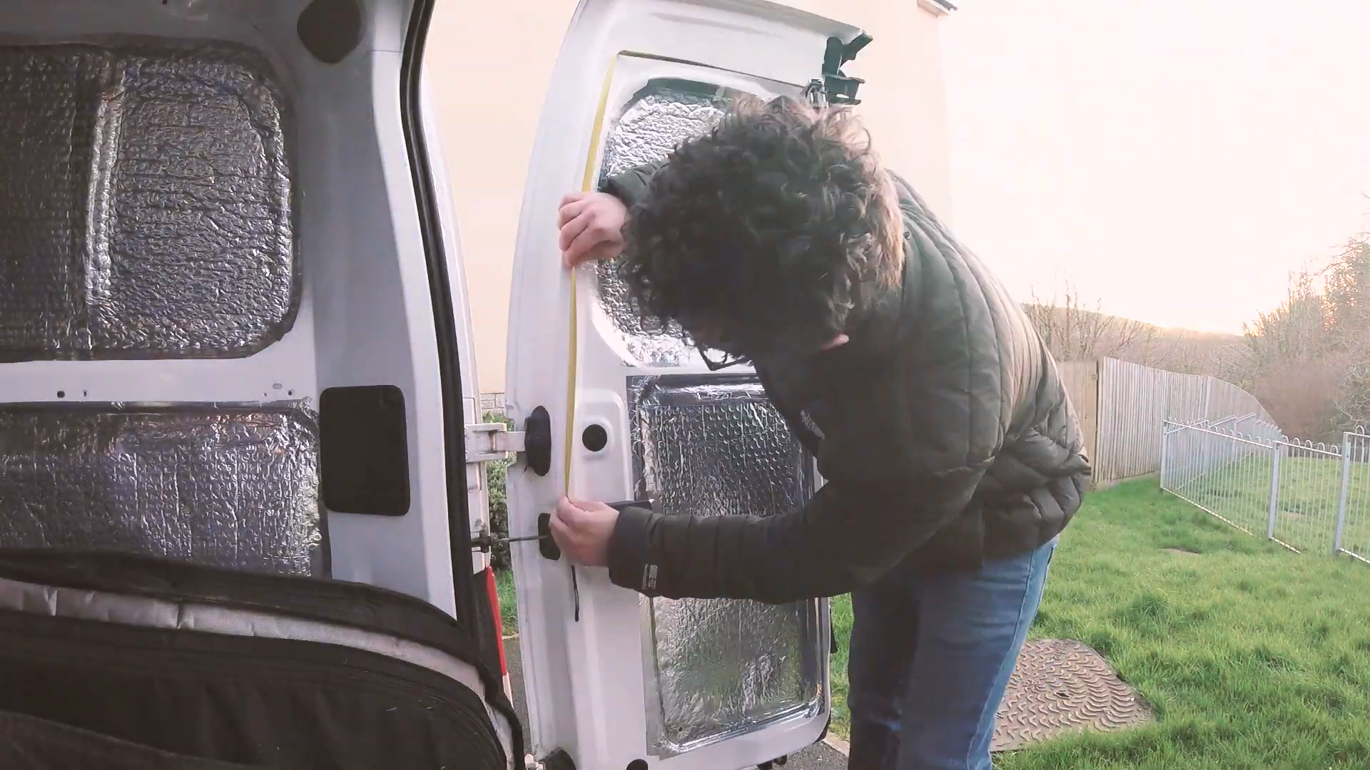 Measuring the van door to work out rubber quantities