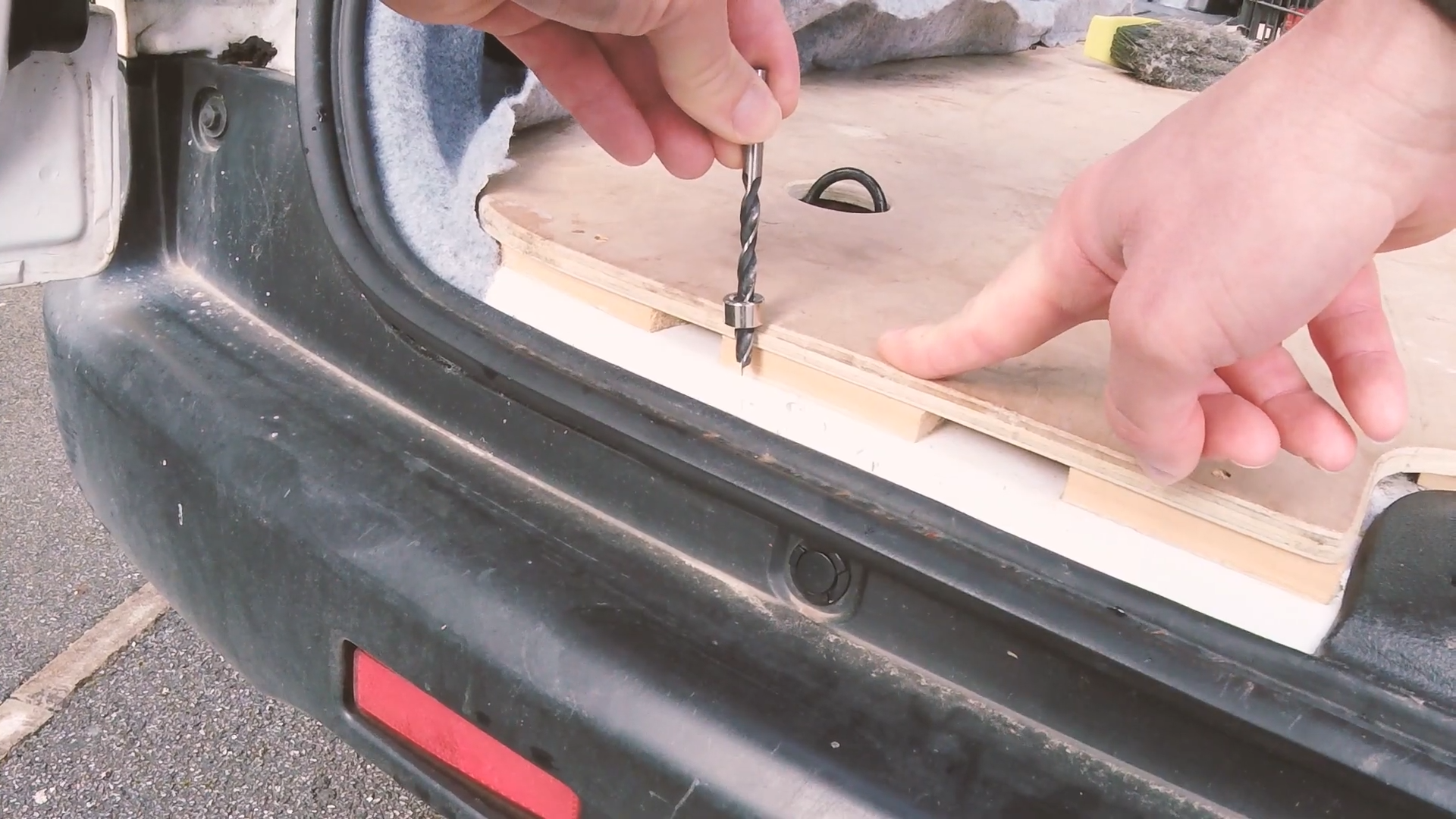 A drill bit with a collar held against the depth of the van floor edge