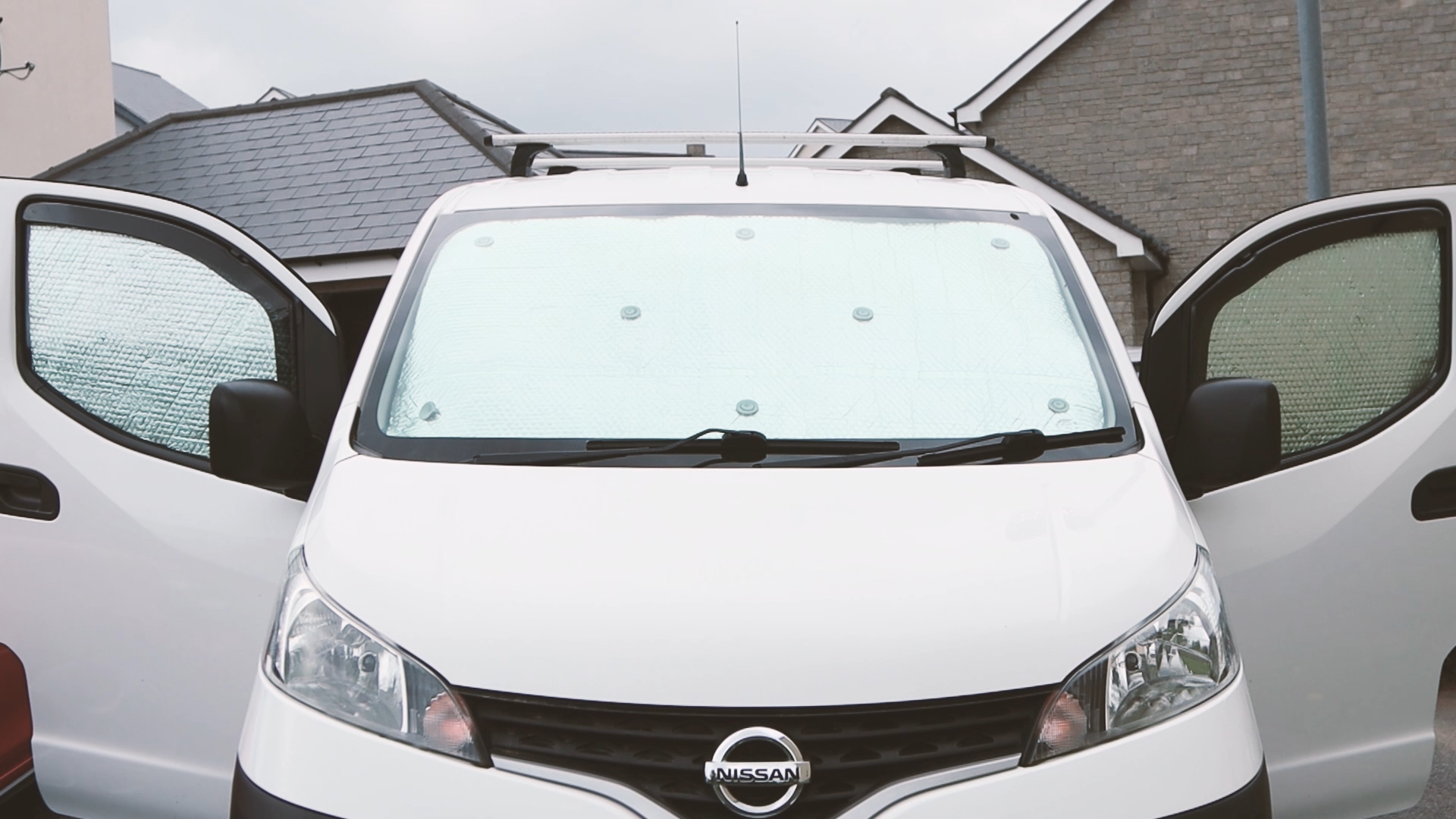 Small panel van with DIY thermal blackout window covers